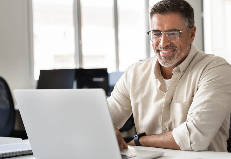 Active senior professional still working past age 65 at their desk